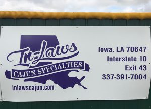 Softball Field Sign - InLaws Cajun Specialties - Banner hanging at Iowa High School, Louisiana